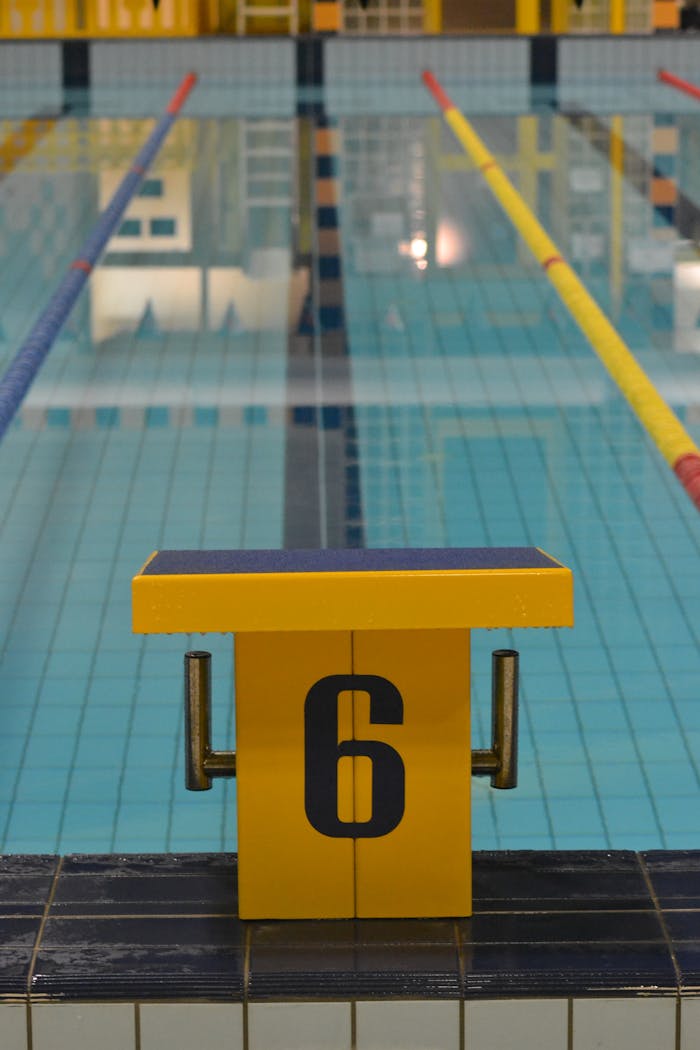 Indoor swimming pool with starting block number six, perfect for pool sports and training.
